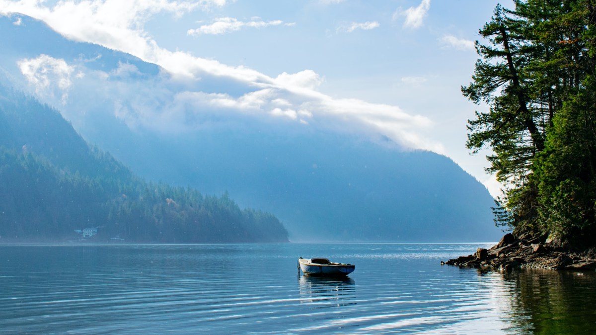 An empty row boat sits on Harrison Lake in British Columbia.