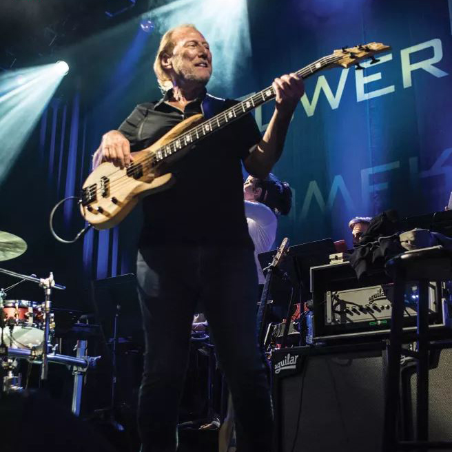 Rocco Prestia plays bass at a concert.